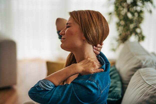 A woman holding her neck in pain due to whiplash from a car accident.